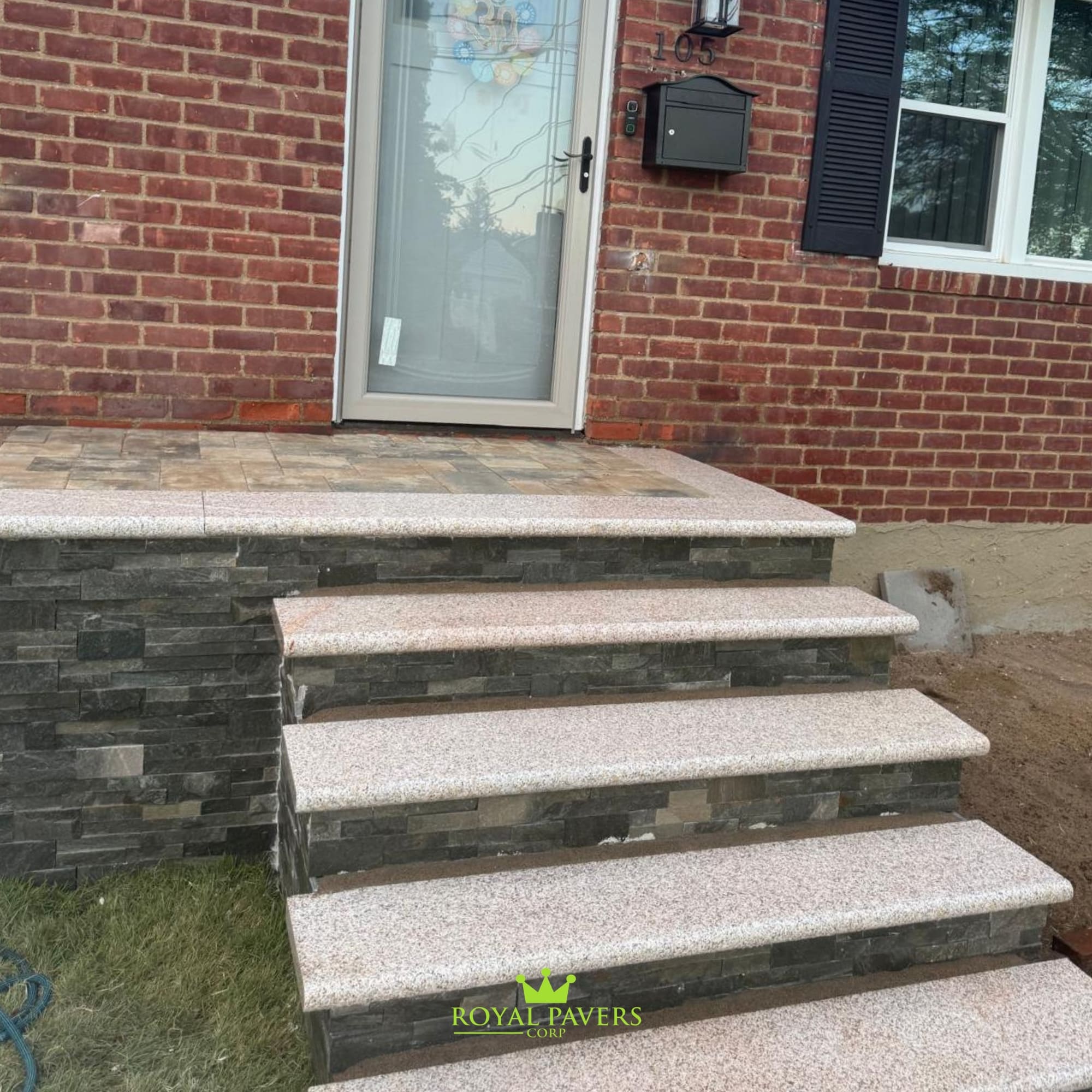 Detailed close-up of custom front steps by Royal Pavers Corp